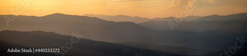 Silhouettes of the Carpathian mountains in the haze at sunset © onyx124