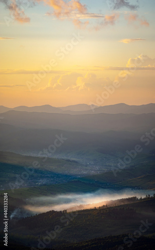 Silhouettes of the Carpathian mountains in the haze at sunset