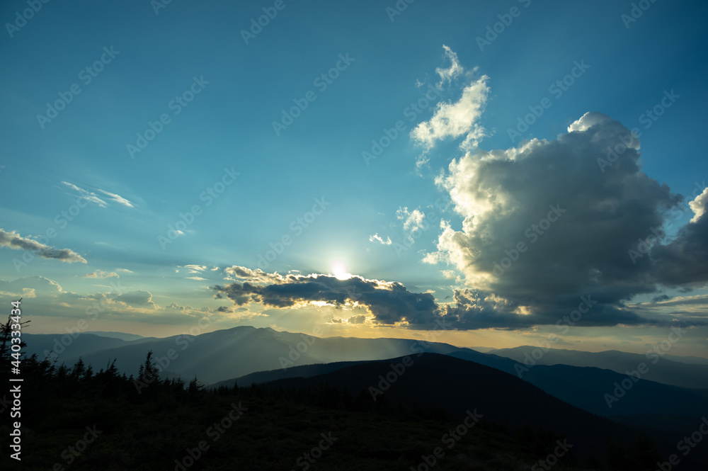 Sun rays and beautiful sky at sunset in the Carpathian mountains