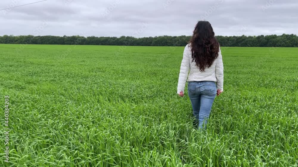 4k Girl walking across green bright field. 4k Girl walking across green bright field.
