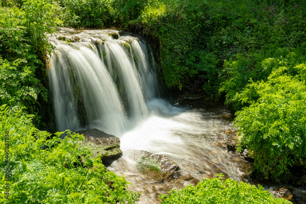 Long exposure of a waterfall flowing onto Lee Abbey Beach in Devon Long exposure of a waterfall flowing onto Lee Abbey Beach in Devon