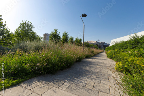 Milano, Italy - June 18, 2021: street view of Piazza Tre Torri in Milan during a summer daylight, buildings are visible against a clear blue sky. photo