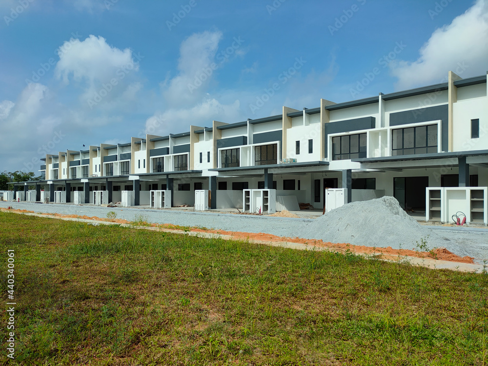 SEREMBAN, MALAYSIA -JUNE 17, 2021: New double-story terrace house under construction in Malaysia. Designed by an architect with a modern and contemporary style. Almost completed. SEREMBAN, MALAYSIA -JUNE 17, 2021: New double-story terrace house under construction in Malaysia. Designed by an architect with a modern and contemporary style. Almost completed.