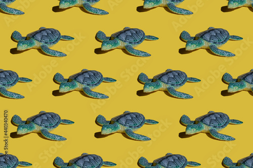 Summer bright concept - blue turtle on a yellow background. Seamless bright pattern