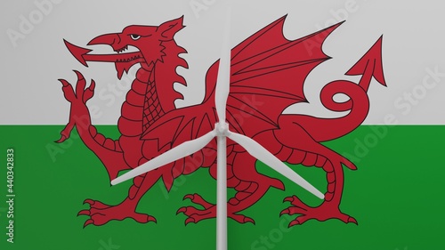 Large wind turbine in center with a background of the flag of Wales