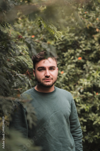 Portrait of a young Caucasian man in a park