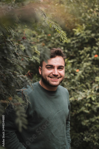 Portrait of a young Caucasian man in a park