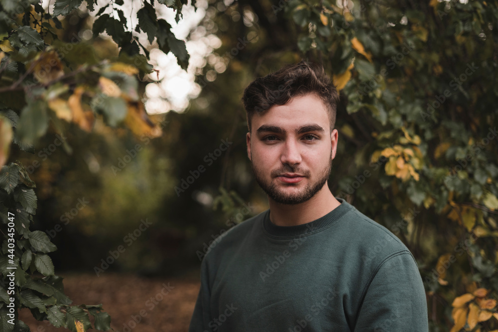 Portrait of a young Caucasian man in a park Portrait of a young Caucasian man in a park