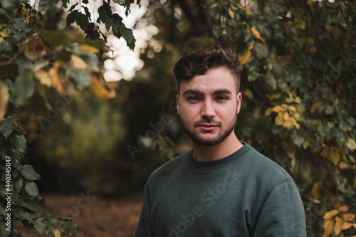 Portrait of a young Caucasian man in a park