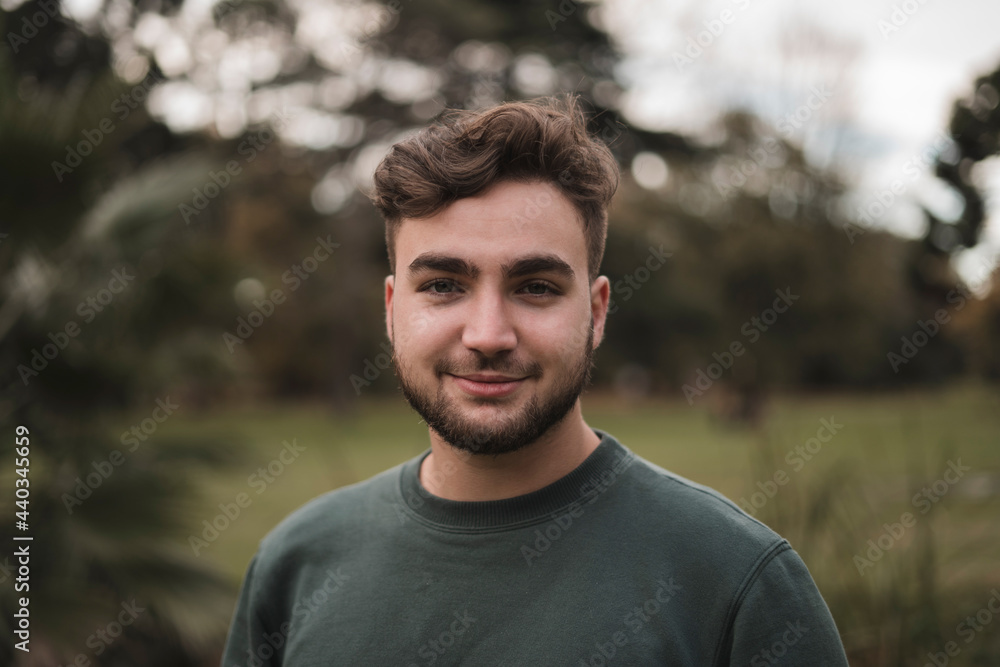 Portrait of a young handsome Caucasian man in a park Portrait of a young handsome Caucasian man in a park