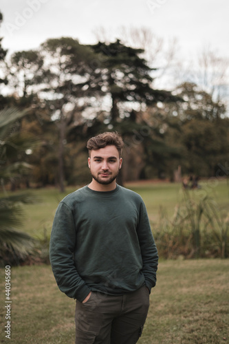 Portrait of a young Caucasian man in a park