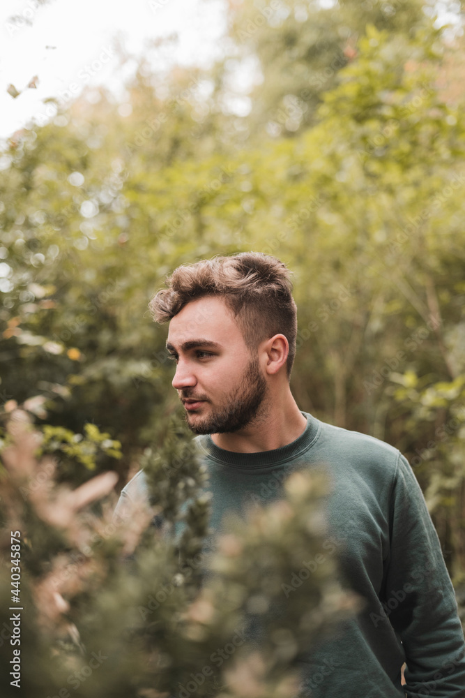 Portrait of a young handsome Caucasian man in a park Portrait of a young handsome Caucasian man in a park