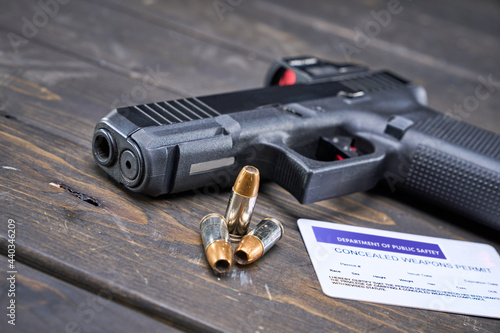concealed carry permit with handgun and self-defense bullets photo