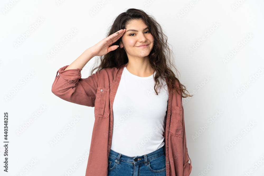 Teenager Russian girl isolated on white background saluting with hand with happy expression Teenager Russian girl isolated on white background saluting with hand with happy expression