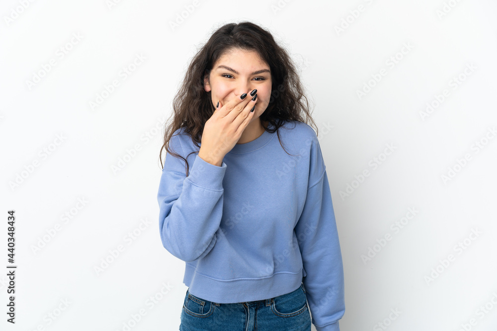 Teenager Russian girl isolated on white background happy and smiling covering mouth with hand Teenager Russian girl isolated on white background happy and smiling covering mouth with hand