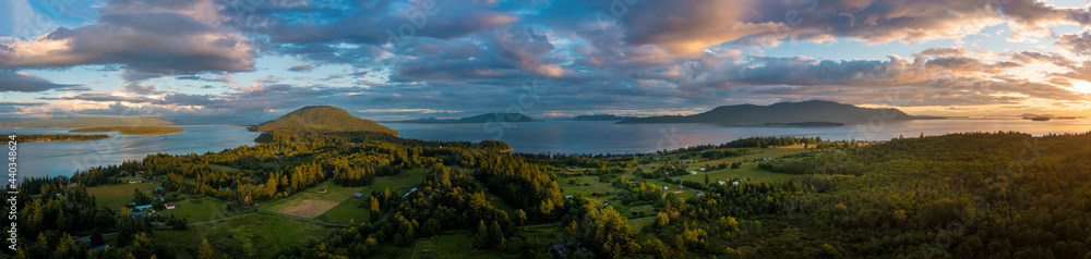 Springtime Aerial Sunset Over Lummi Island, Washington. Lovely, colorful evening on an island in western Washington. Puffy clouds and warm light make for a wonderful evening in the Salish Sea.