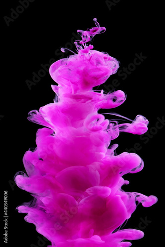 Pink paint in water isolated on black background