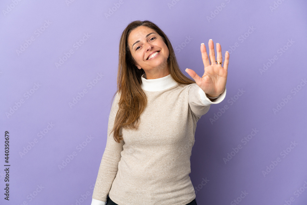 Middle age Brazilian woman isolated on purple background counting five with fingers Middle age Brazilian woman isolated on purple background counting five with fingers