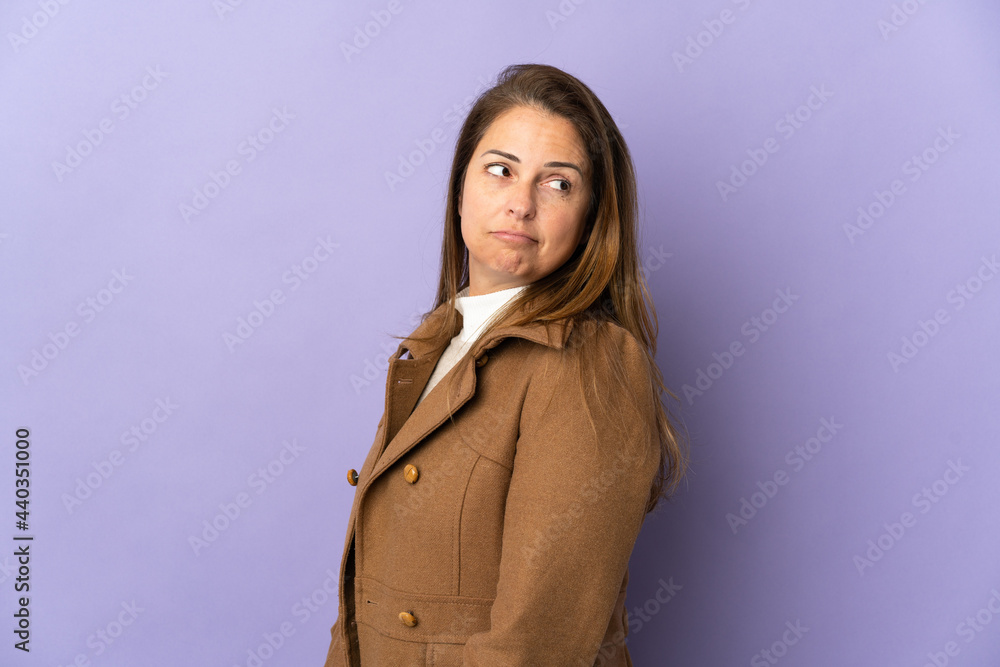 Middle age Brazilian woman isolated on purple background . Portrait