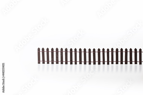 Building wall, fence , or obstacle. Miniature picket fence isolated on white background. Concept image for divides and obstacles.
