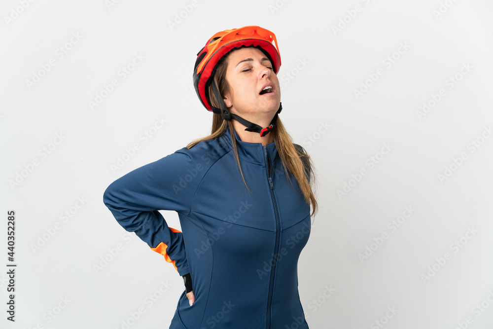 Middle age cyclist woman isolated on white background suffering from backache for having made an effort Middle age cyclist woman isolated on white background suffering from backache for having made an effort