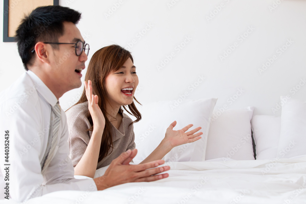 Happy Asian family spending a time together in bedroom.