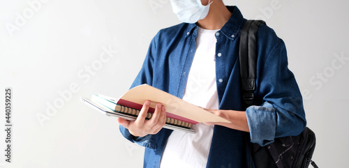 Young asian campus student man wearing protection mask while walking in campus, coronavirus prevention in university, social distancing