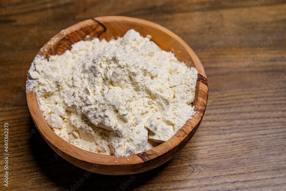 flour in a wooden dish on the kitchen table. flour in a wooden dish on the kitchen table.