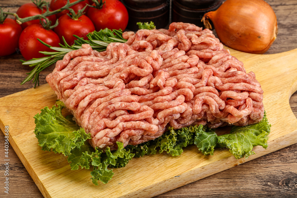 Raw pork minced meat over board Raw pork minced meat over board
