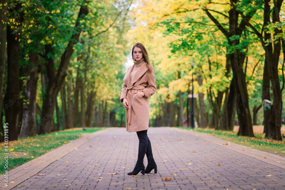 Beautiful woman spending time in park during autumn season Beautiful woman spending time in park during autumn season
