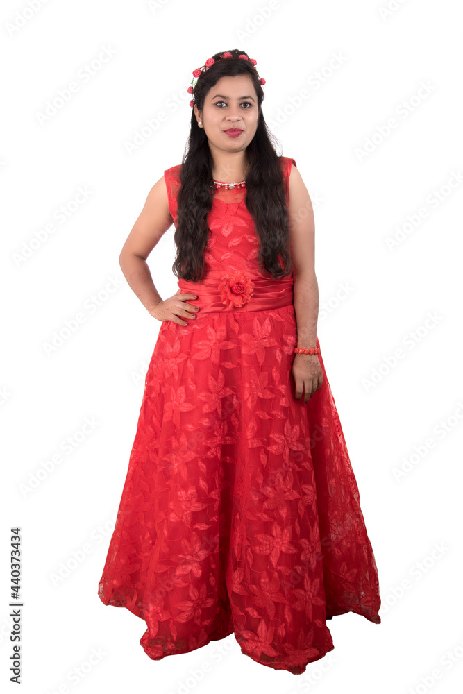 Young girl in red dress posing on white background