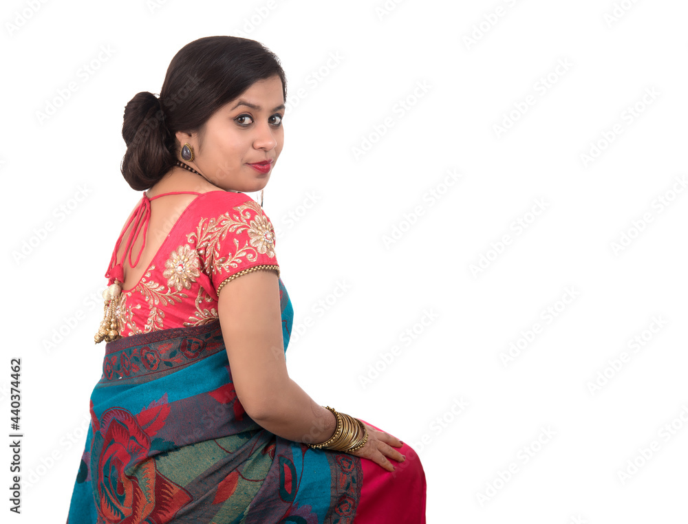 Beautiful young girl posing in Indian traditional saree on white background. Beautiful young girl posing in Indian traditional saree on white background.