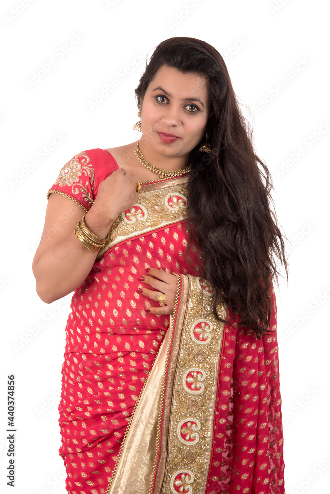 Beautiful young girl posing in Indian traditional saree on white background. Beautiful young girl posing in Indian traditional saree on white background.
