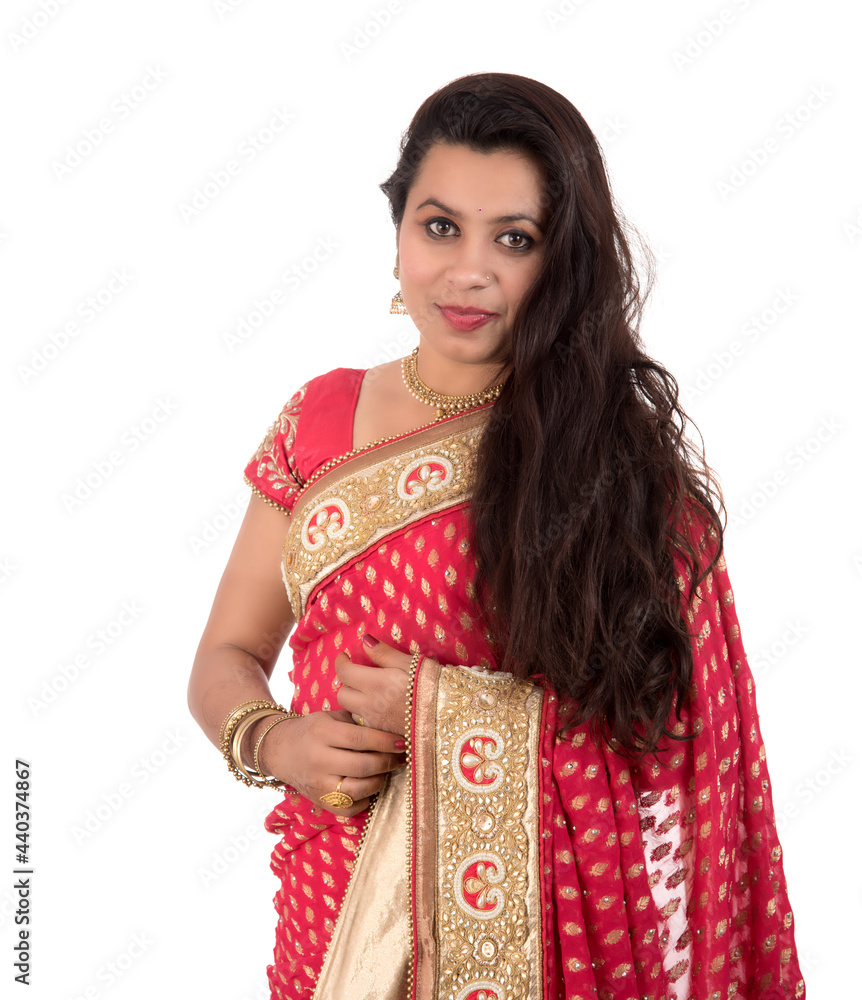 Beautiful young girl posing in Indian traditional saree on white background. Beautiful young girl posing in Indian traditional saree on white background.