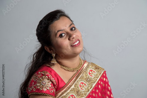 Beautiful young girl posing in Indian traditional saree on white background.