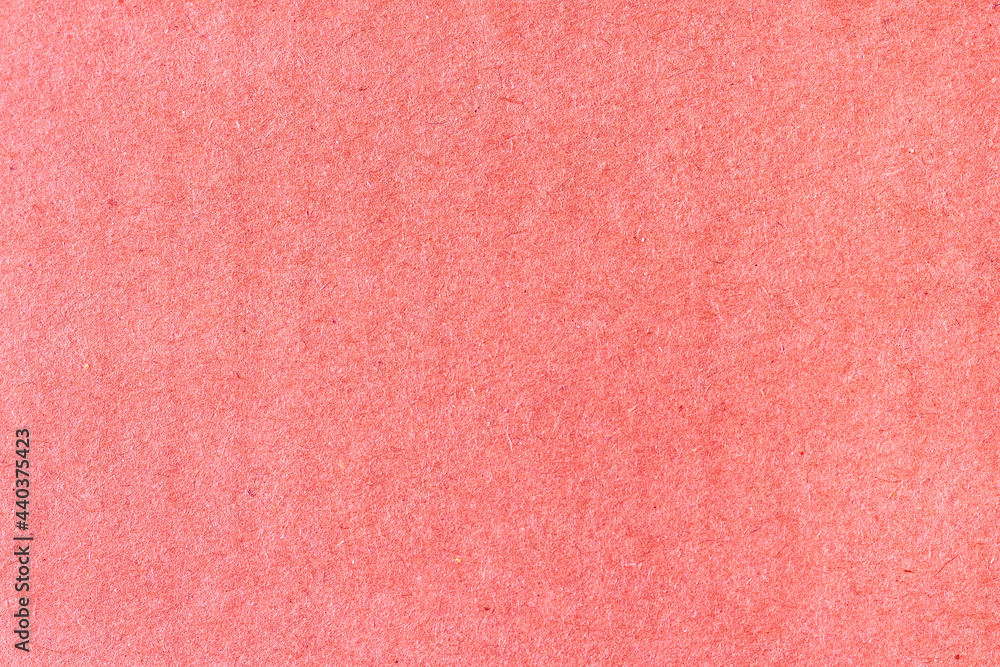 Fototapeta premium A sheet of red colored paper. Rough smooth texture.