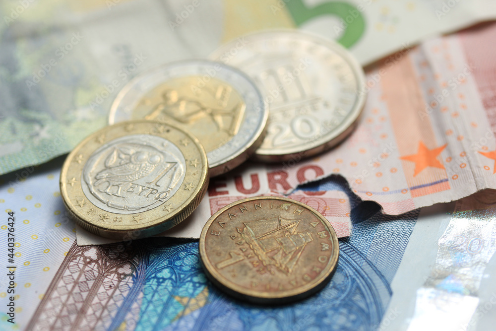 Greek coins on euro notes Greek coins on euro notes