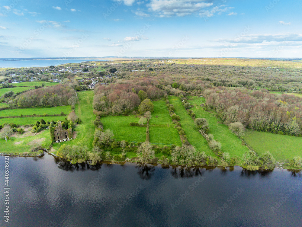 Aerial view on river Corrib and Menlo castle, Galway, Ireland, Warm sunny day, blue sky. Green fields and small forest. Irish country side. Nobody.