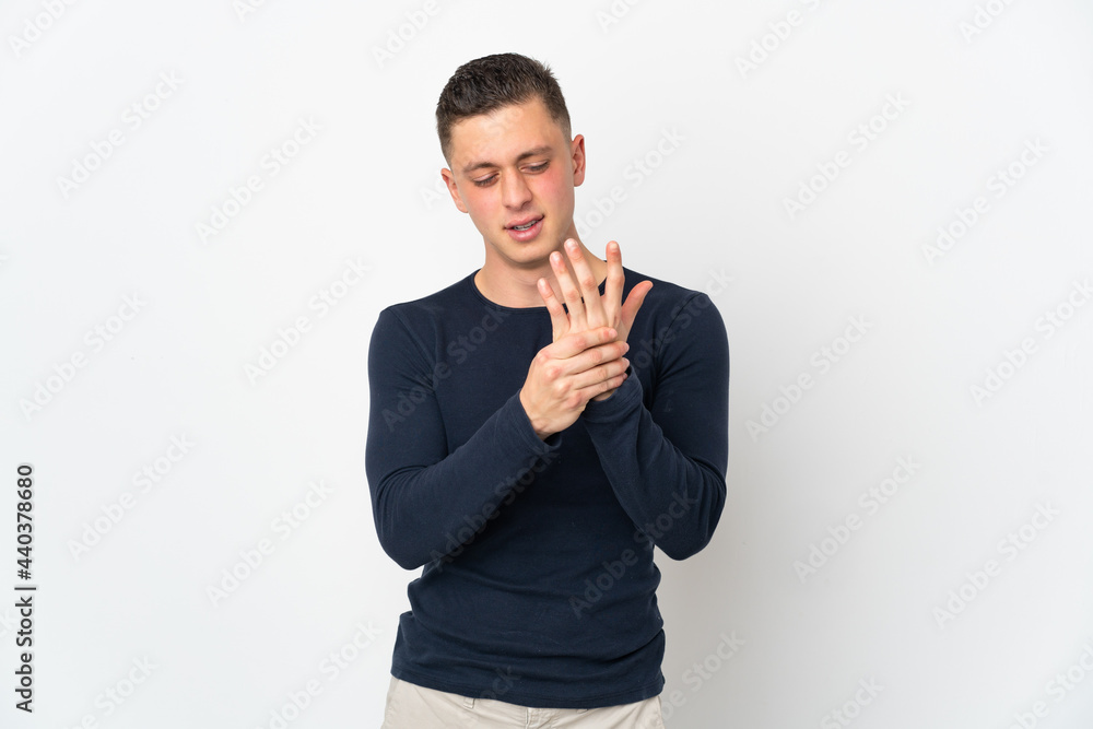 Young caucasian man isolated on white background suffering from pain in hands Young caucasian man isolated on white background suffering from pain in hands