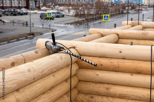 Drill on the wall of abuilding wooden house