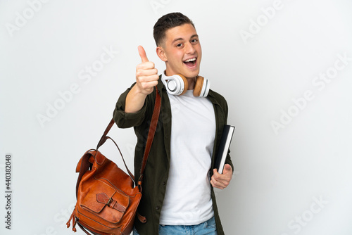 Young caucasian student man isolated on white background with thumbs up because something good has happened