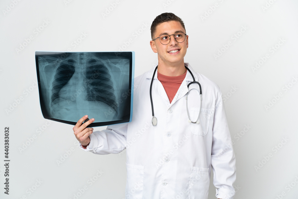 Professional traumatologist on white background thinking an idea while looking up Professional traumatologist on white background thinking an idea while looking up