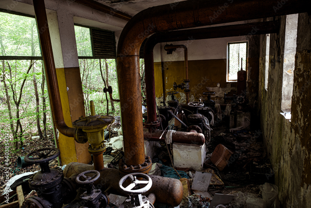 abandoned industrial area with pipes and taps