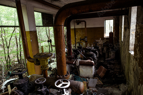 abandoned industrial area with pipes and taps