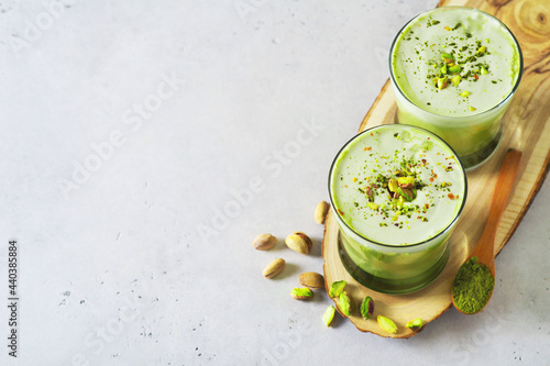 Green matcha latte with pistachios and matcha powder