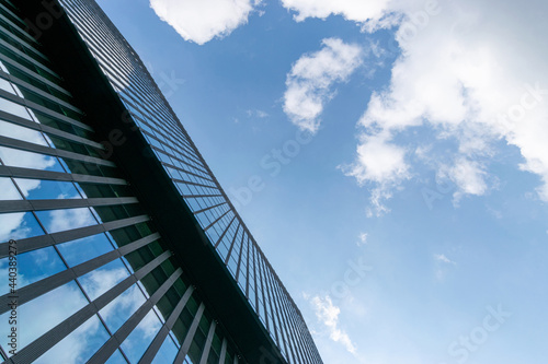 Business building. Modern office business building with glass  steel facade exterior. Finance corporate architecture city in abstract blue sky with nature cloud in sunny day.