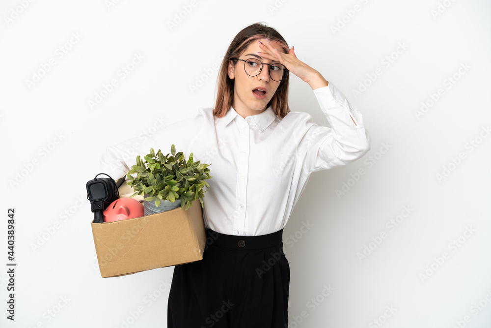 Young caucasian woman moving in new home among boxes isolated on white background doing surprise gesture while looking to the side Young caucasian woman moving in new home among boxes isolated on white background doing surprise gesture while looking to the side