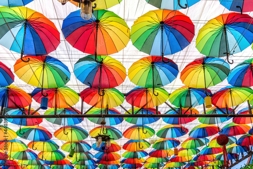 Obraz premium Colorful umbrellas on the ceiling of a summer cafe