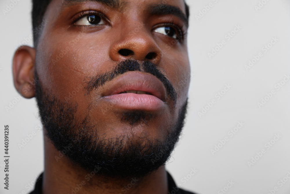 Obraz premium Cropped image of focused millennial african american young serious black man. 
