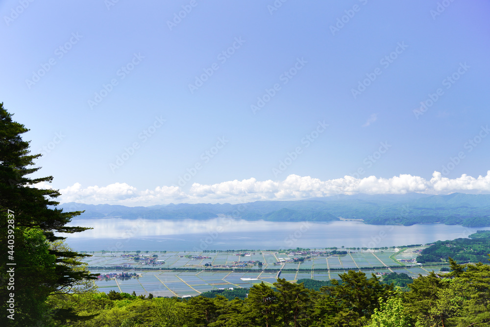 福島県・磐梯山から見下ろす田植え後の、猪苗代の町と猪苗代湖